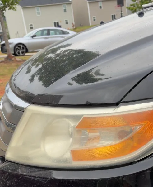 Black SUV headlight, our own work, before restoration
