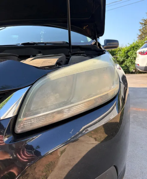Black SUV headlight, our own work, before restoration